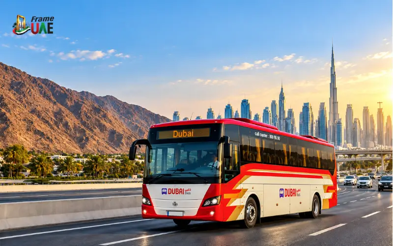 Fujairah to Dubai bus on a highway with Dubai skyline and mountains in the background.